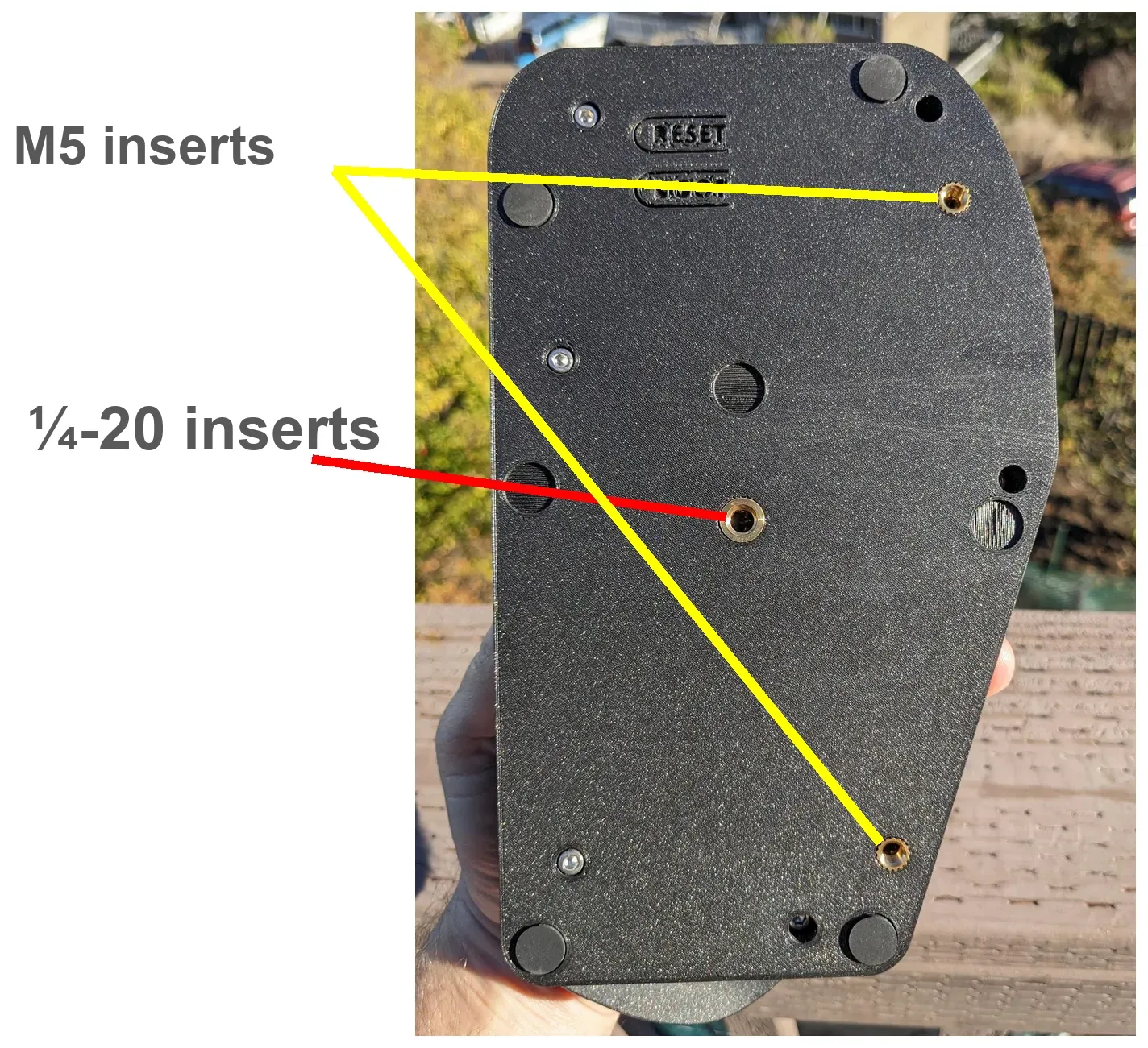 The bottom of a back case. Yellow lines point to the two M5 inserts and a red line to the 1/4-20 insert.