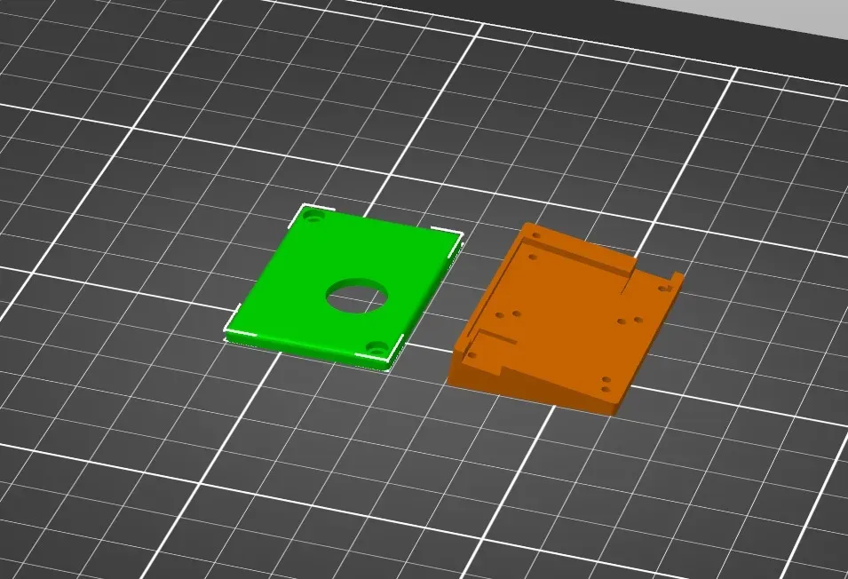 Slicer view of the two TrackPoint case parts lying flat side down.